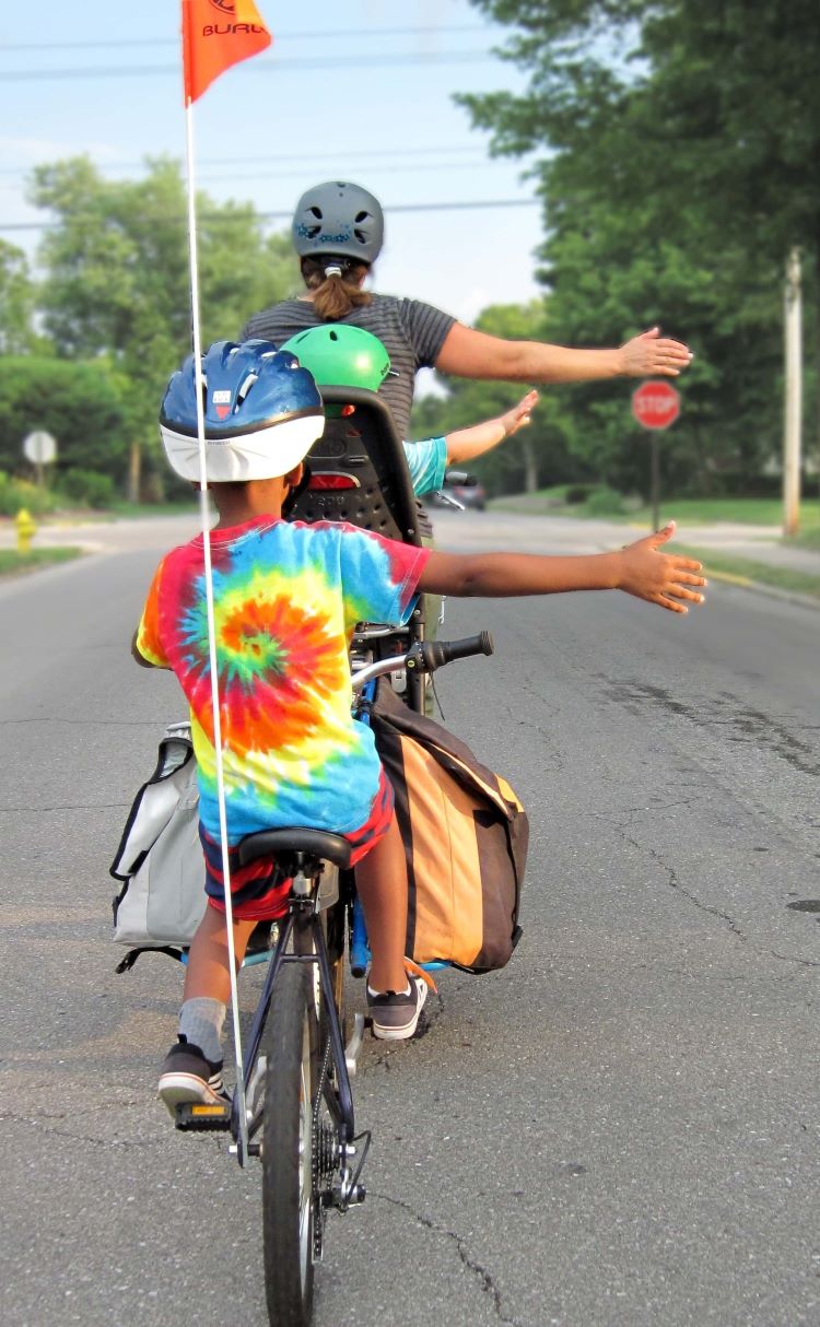 Two people riding bikes.