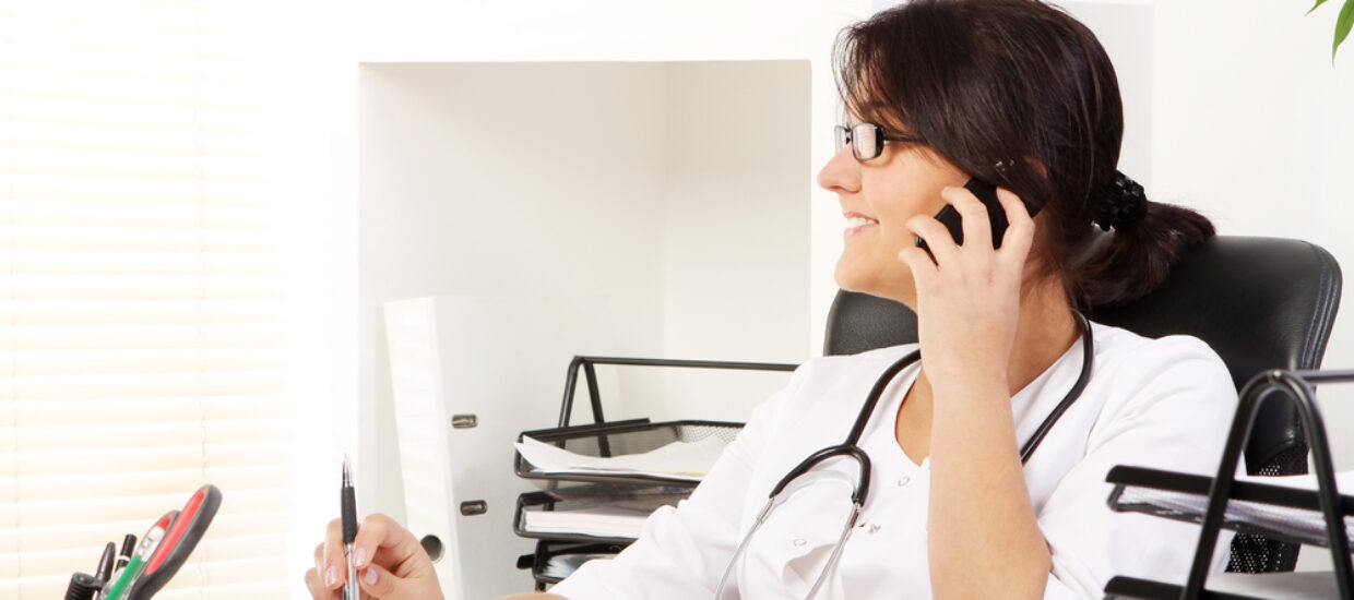 Woman in medical office on the phone