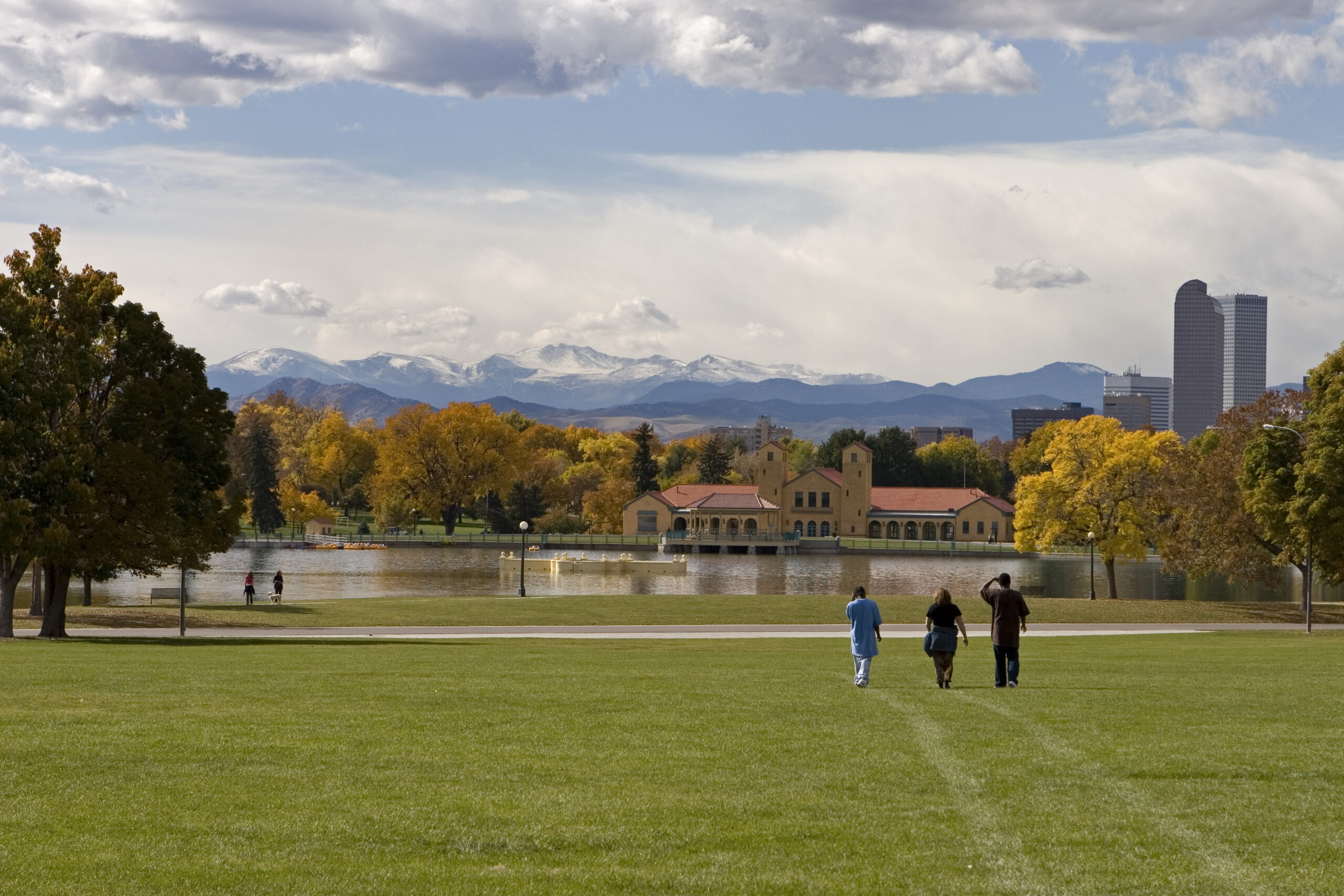 People walking in a park with mountains in the background