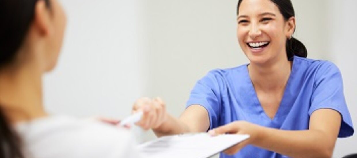 Shot of a patient and assistant interacting in a dentist office