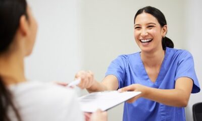 Shot of a patient and assistant interacting in a dentist office