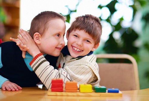 A boy hugging another boy.