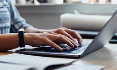 Close up Shot of an Anonymous Young Businesswoman Using a Laptop while Working from Home